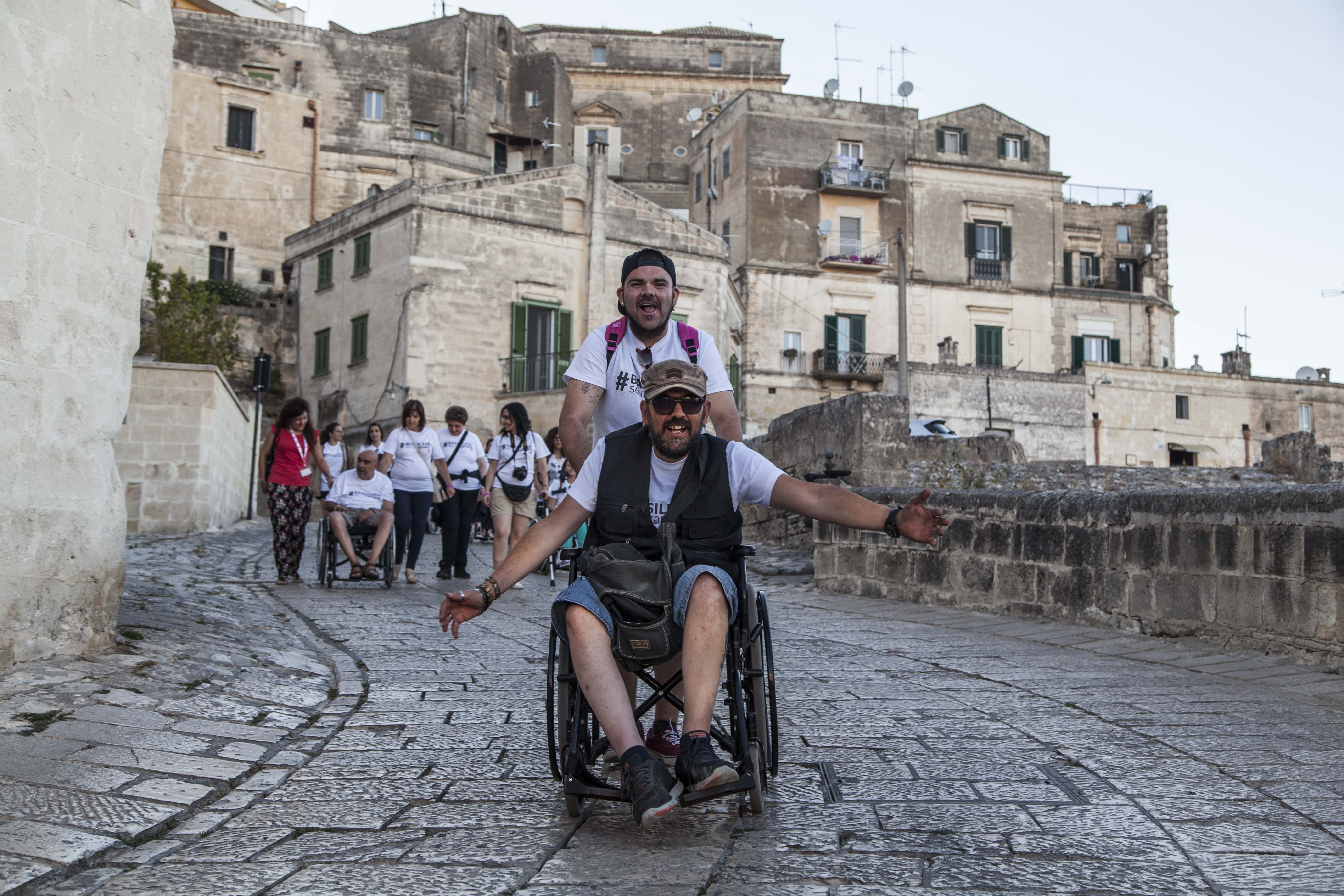 Person with mobility impariments enjoying his holiday in Matera, Italy